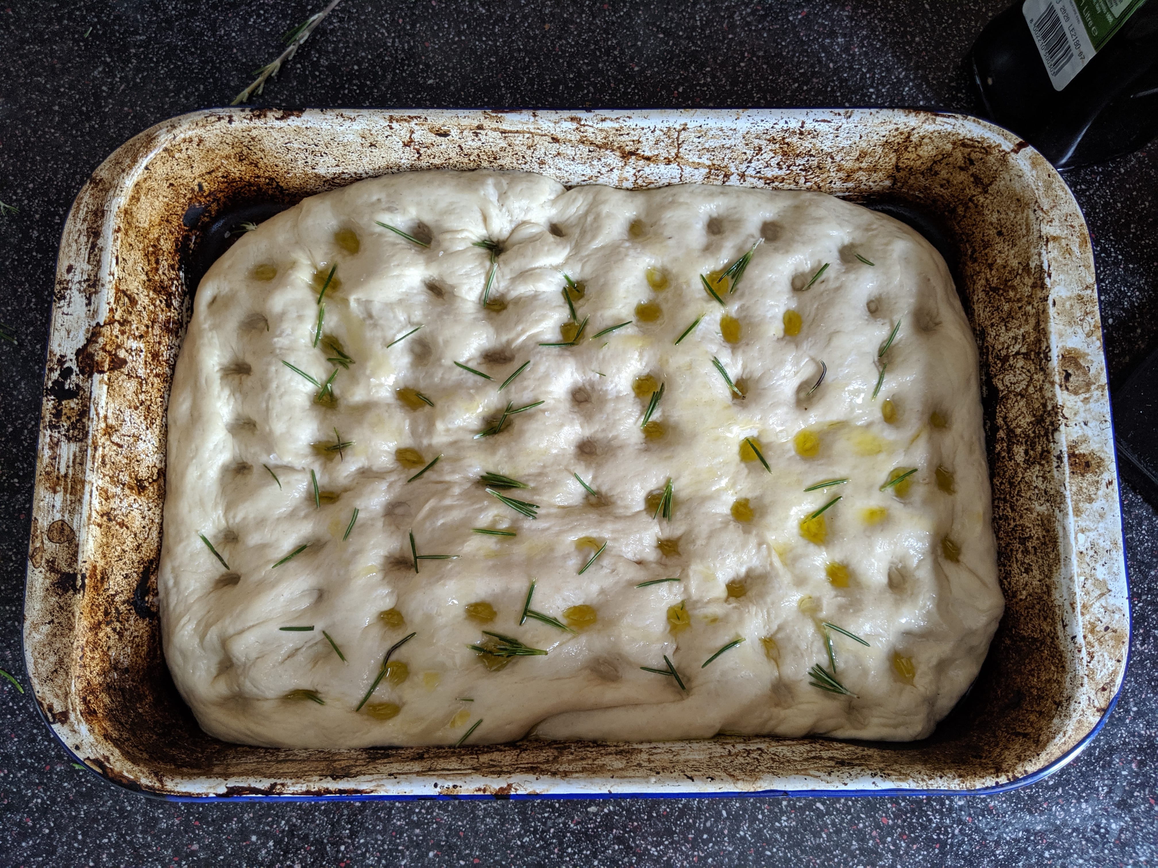 The focaccia dough, covered in rosemary and salt (before the oven)