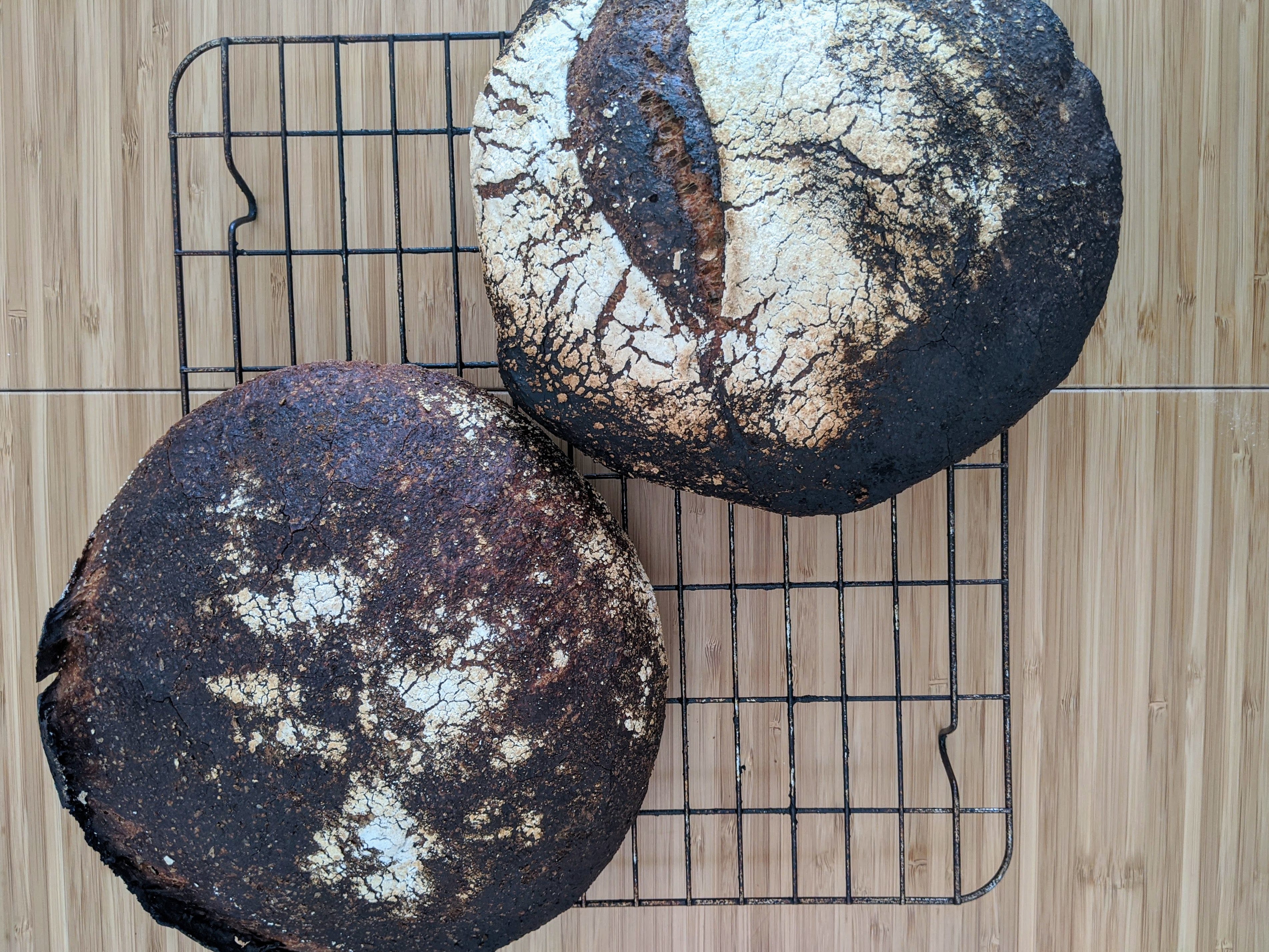 Two darkly baked (almost burnt) loaves